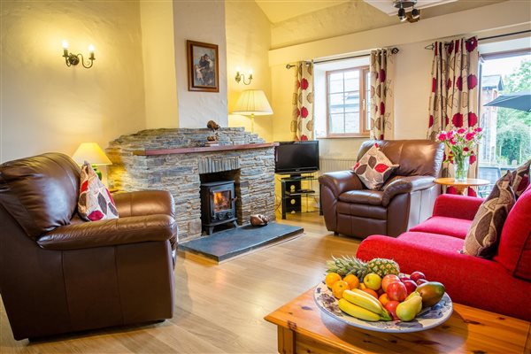 Open plan living room in the Dairy Cottage with log burner